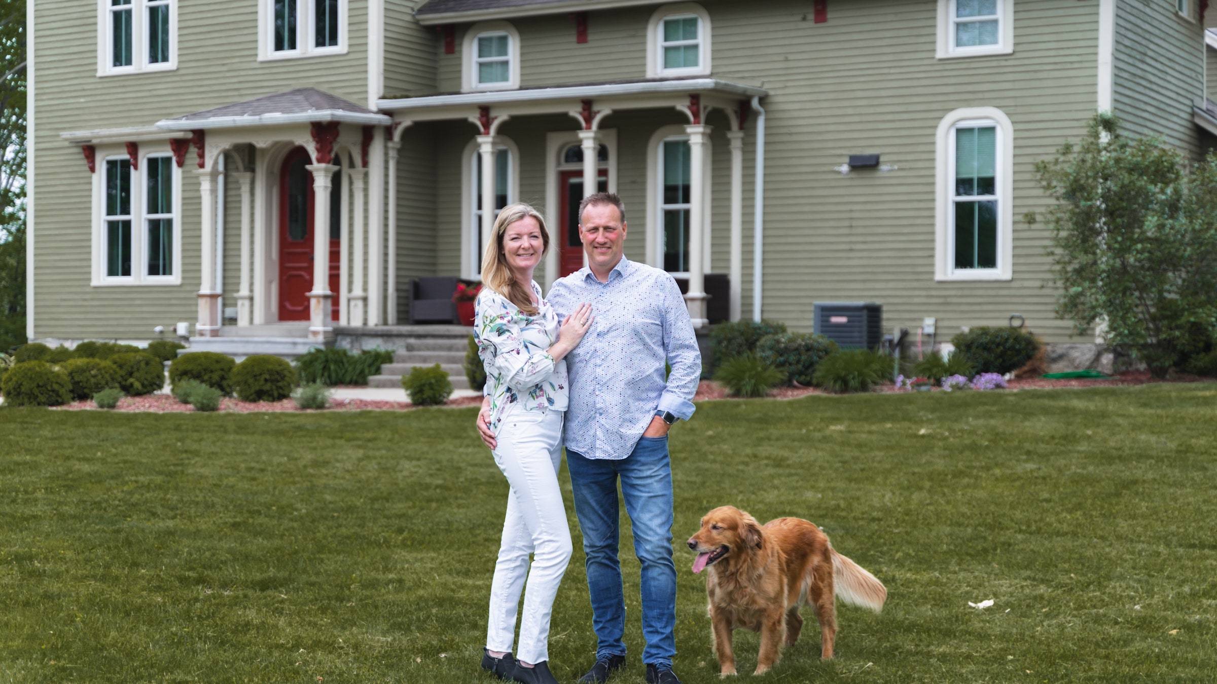 Marjolein and Mario VanderHulst pose for a portrait in front of their farmhouse.