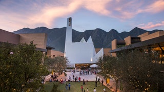 people standing by building moutains background