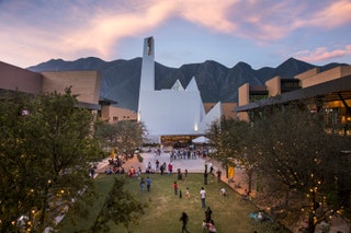 people standing by building moutains background