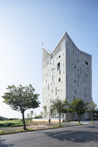 building by trees and one person walking