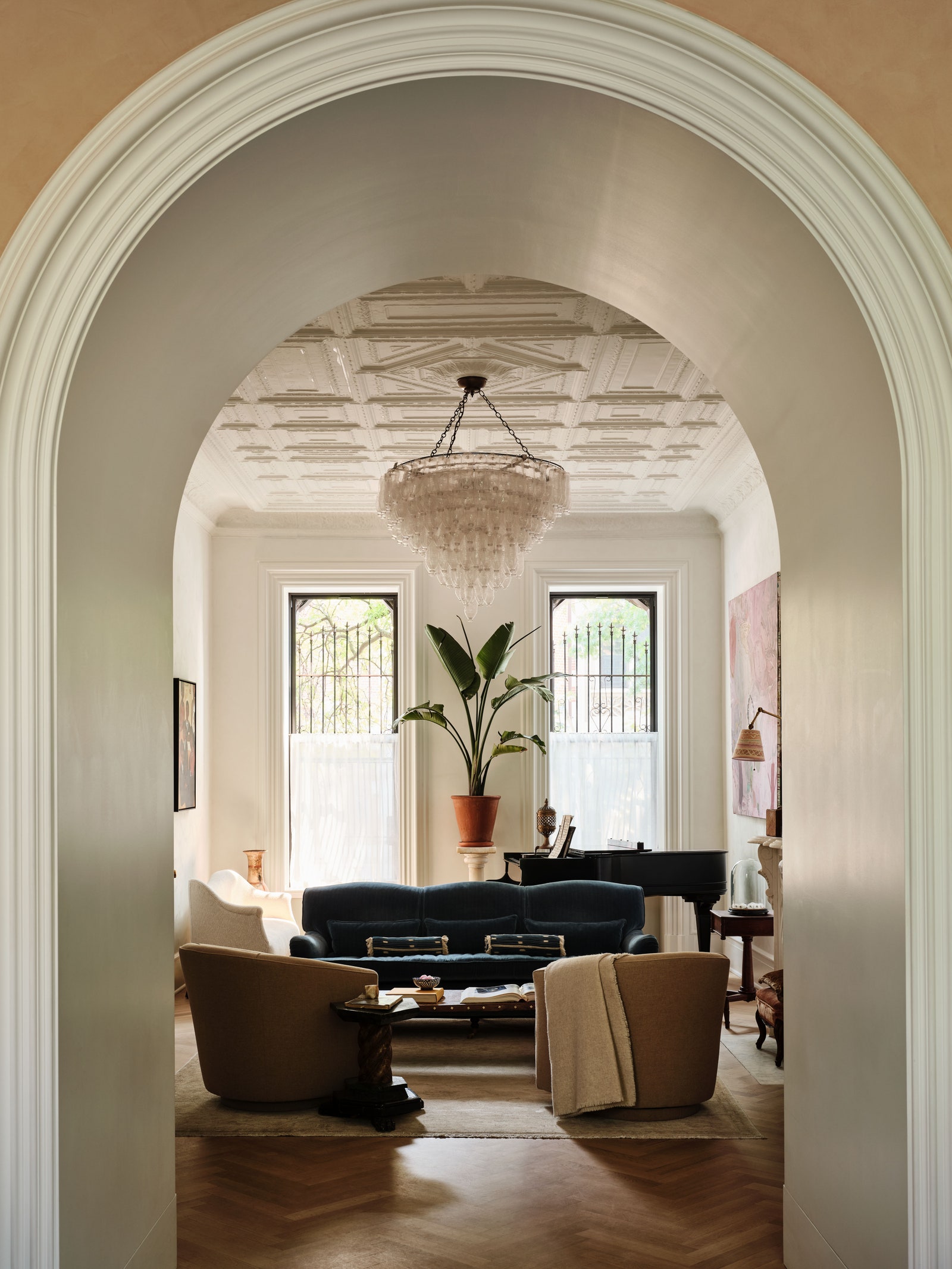 living room with chandelier and blue sofa