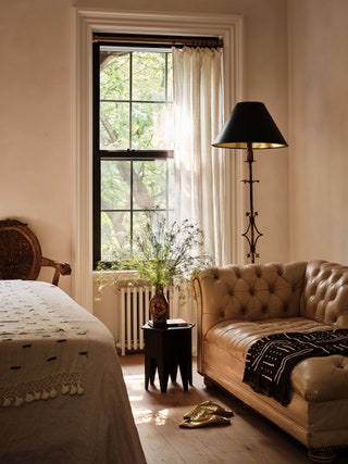 primary bedroom's lounge area with leather chaise longue