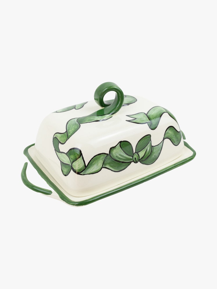 Ceramic butter dish with a painted olive green ribbon design.