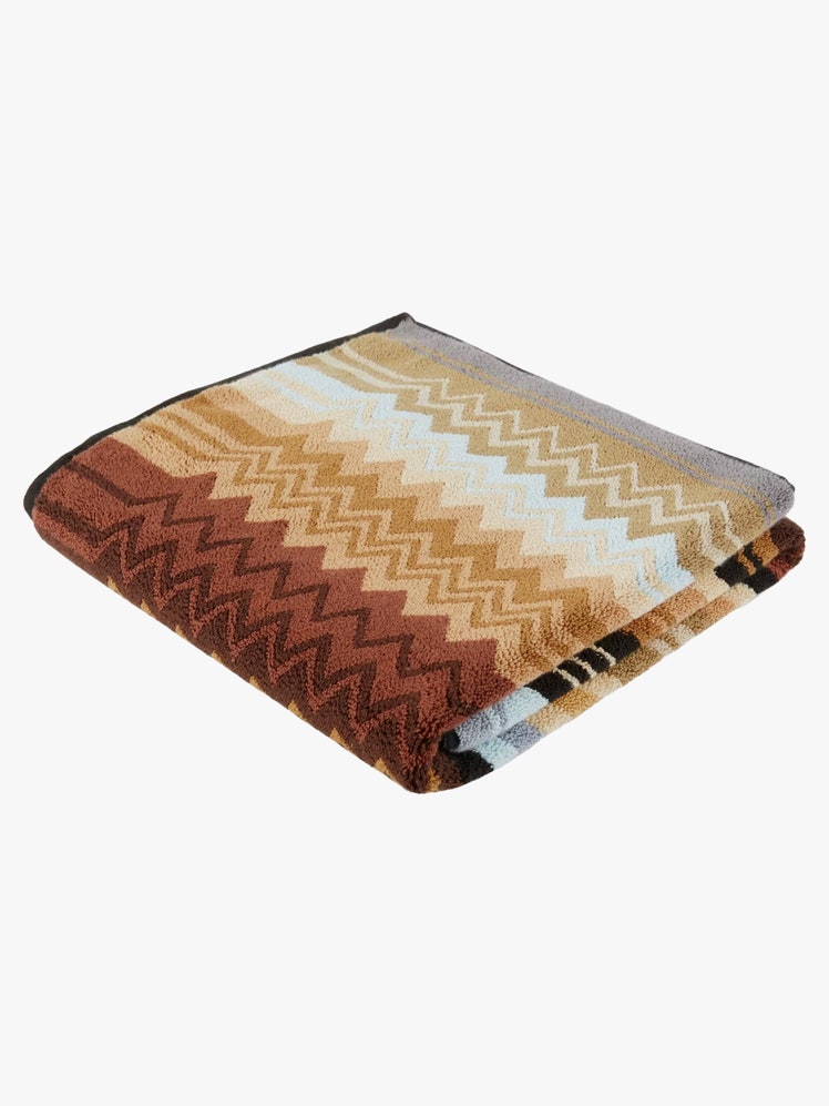 Folded up Missoni Giacomo Bath Mat with a zigzag design.