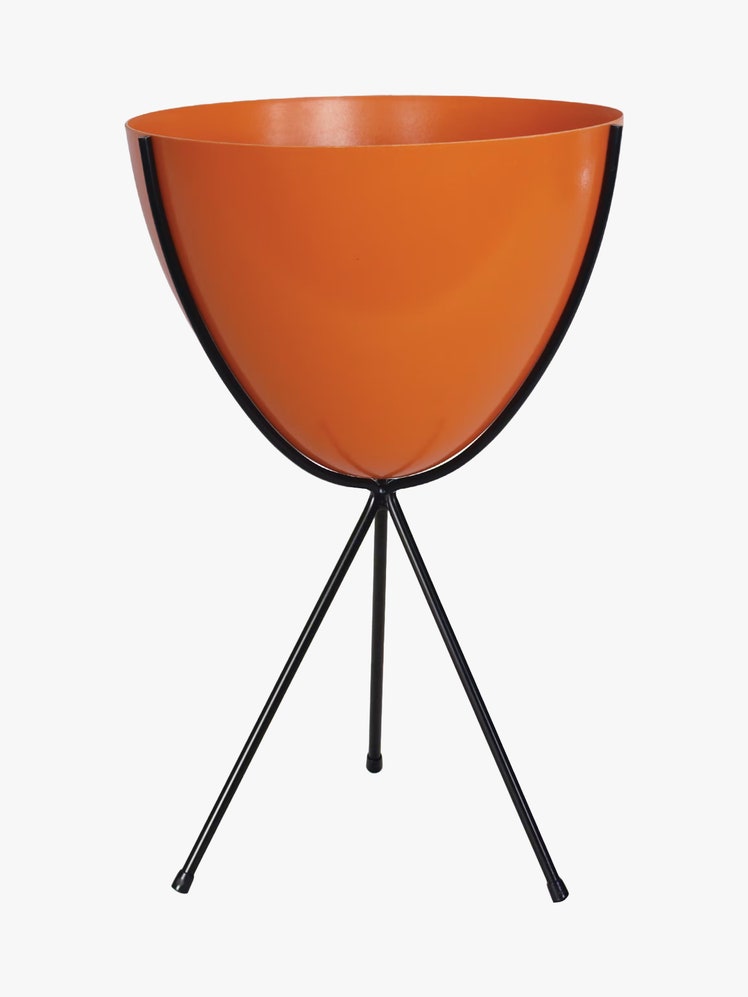 Planter with an orange pot and black metal tripod stand.