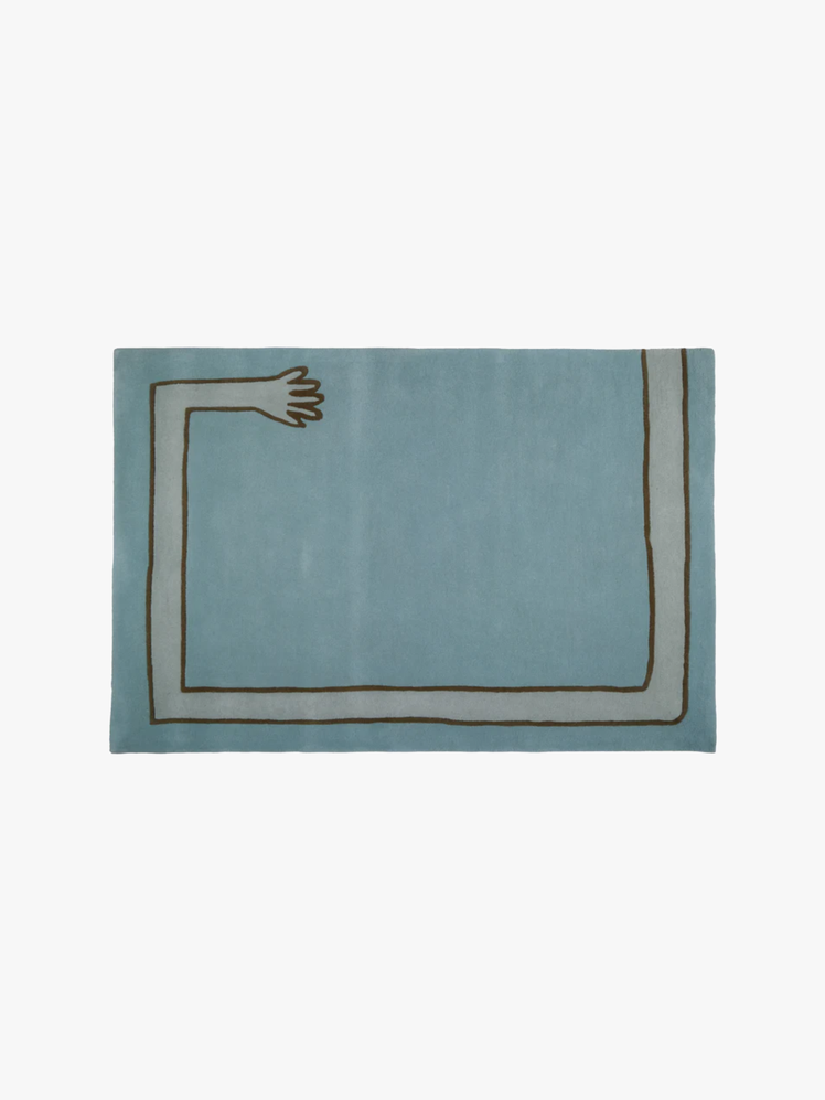 Blue rectangular rug with an arm shaped design around the border.