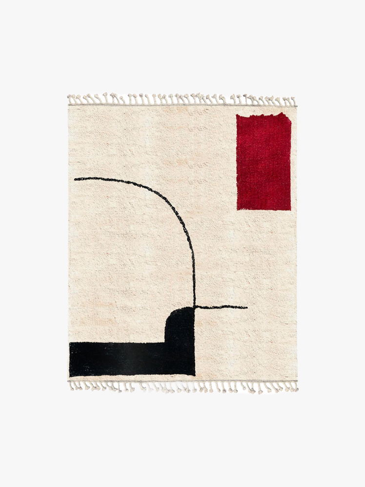 White rug with black and red abstract design.