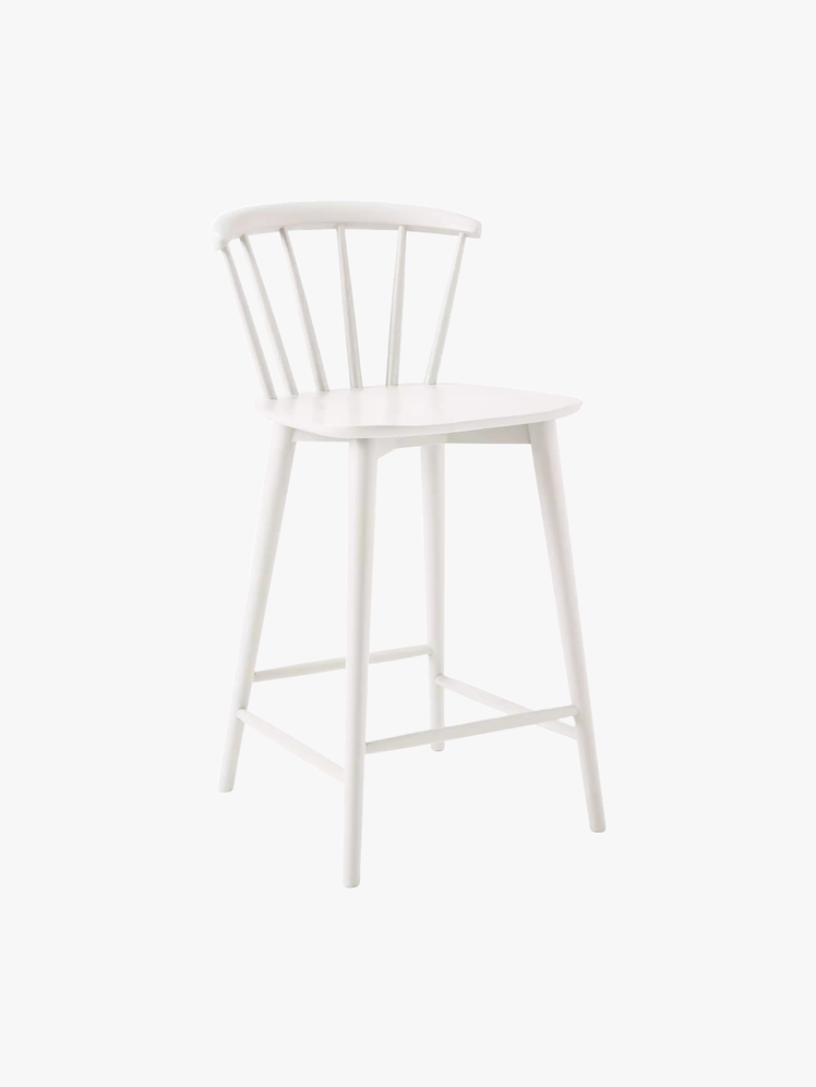 White counter chair with a curved back with spindles.