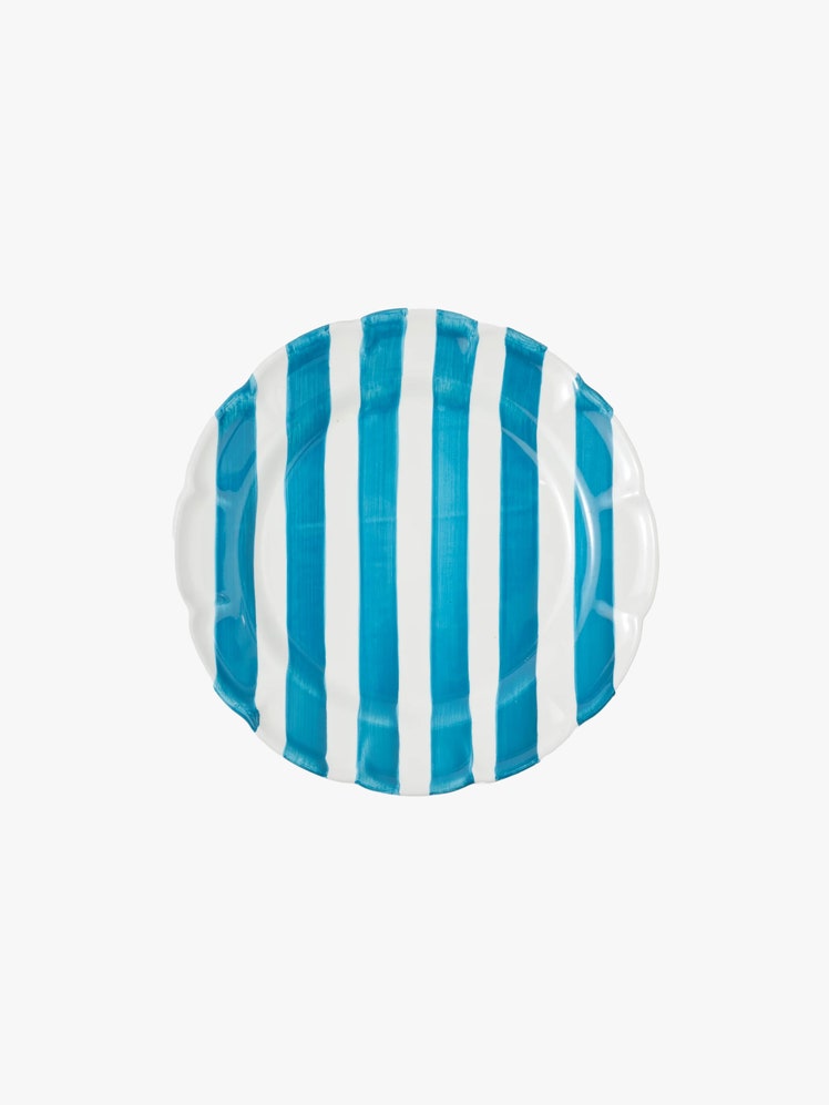 Blue and white striped dinner plate with a scalloped edge.