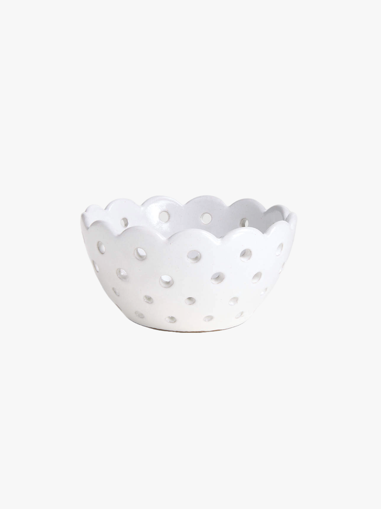 Colander with an eyelet pattern and a scalloped edge.