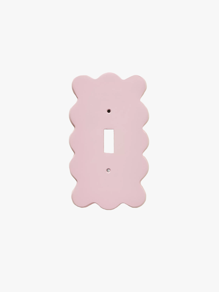 Light switch plate with scalloped edges.