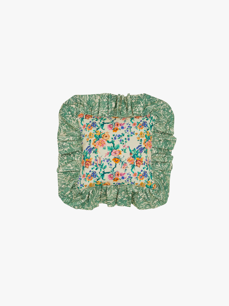 Floral cushion with ruffled edges.