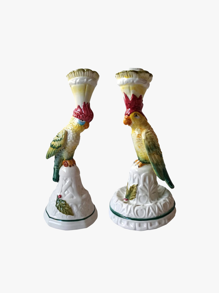 A pair of porcelain parrot figurine candleholders.