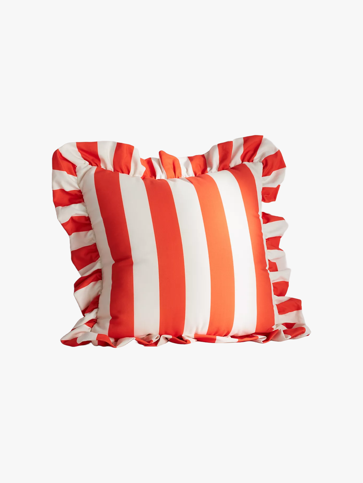 Red and white striped pillow with ruffle around the edge.