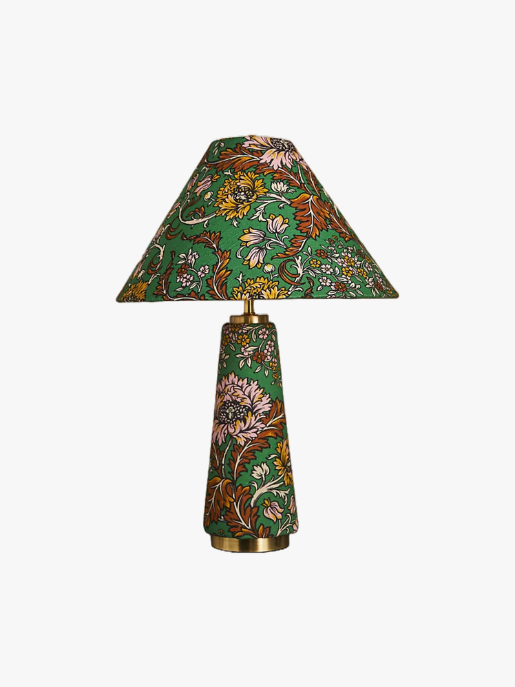 Table lamp with a green pink yellow and brown botanical pattern across both the base and lampshade.