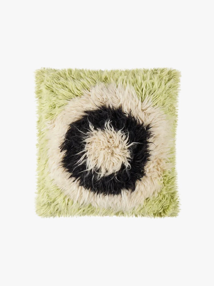 Green black and white fuzzy pillow.