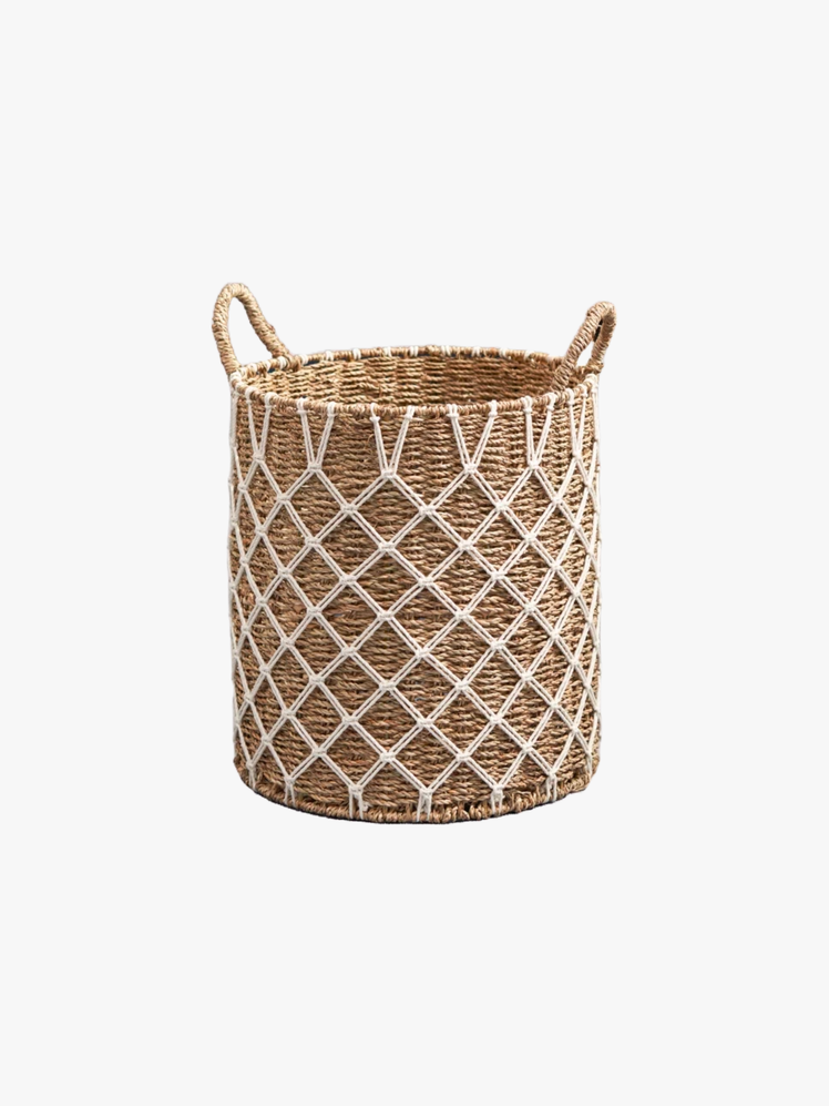 Woven basket with a handle on each side adorned with netted yarn.