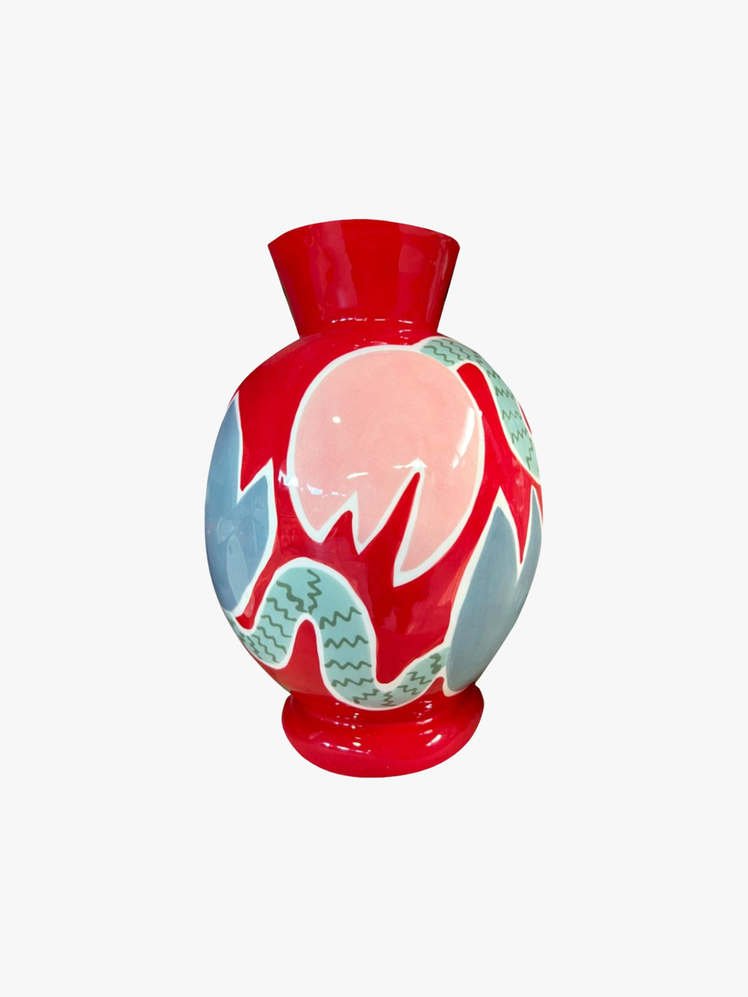 Red vase with a wide brim and handpainted picture of abstract tulips.