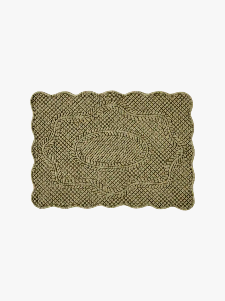 Olive green quilted cotton placemat with scalloped edges.