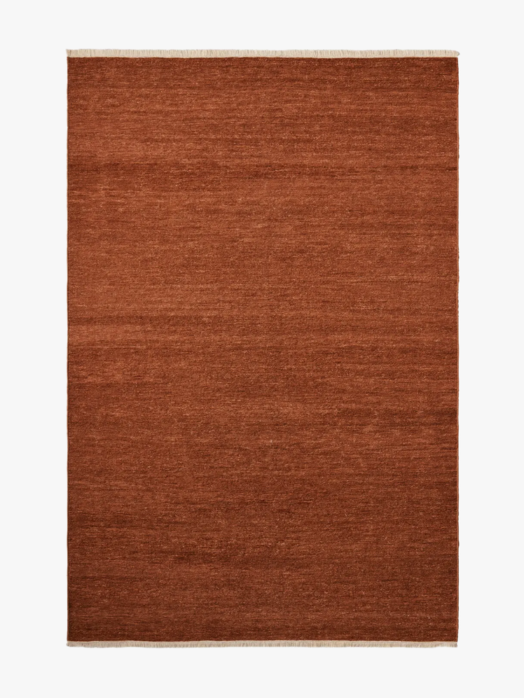 Rectangular rug with a soumak weave which gives it a chevron pattern in terracotta color.