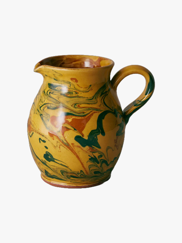 Ceramic pitcher with a goldenrod green and red marbled glaze.