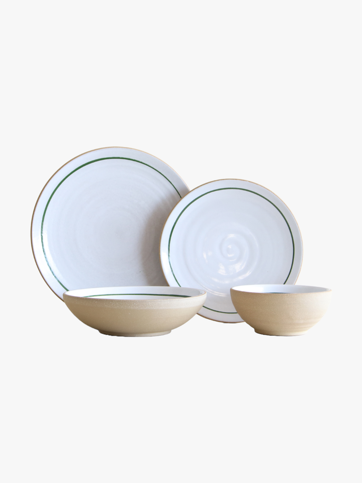 Two plates and two bowls with white glazed interiors and raw clay exteriors.