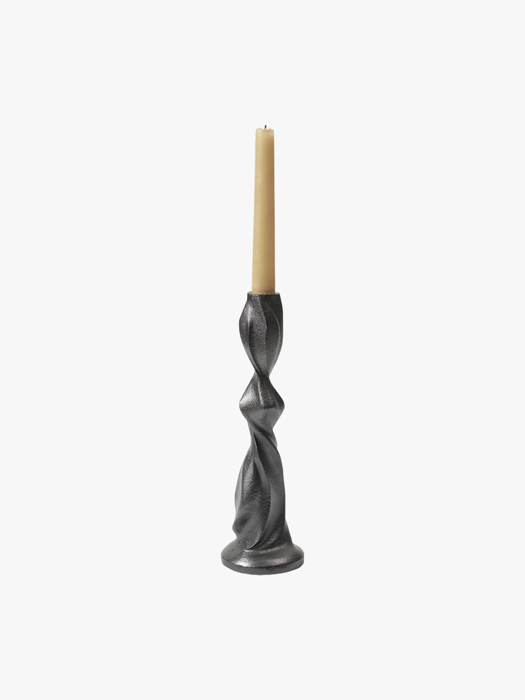 Metal candlestick with twisting shape holding a taper candle.