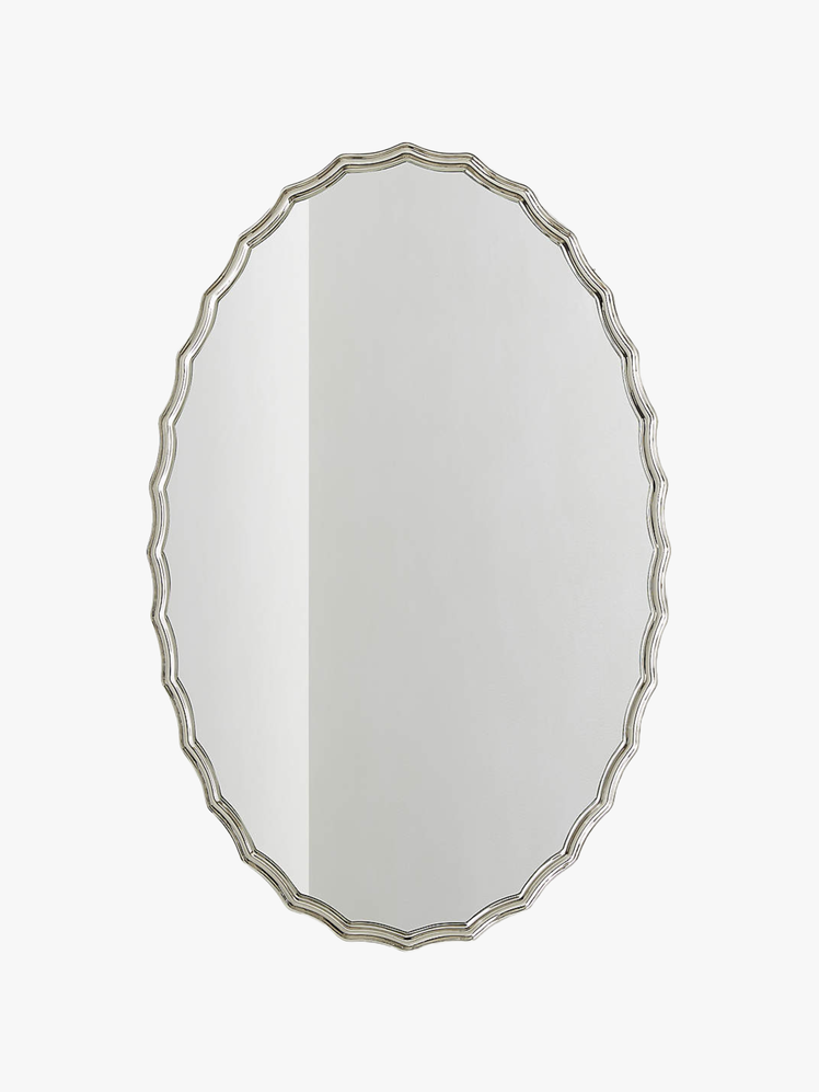 Oval mirror with scalloped edges on a polished nickel frame.