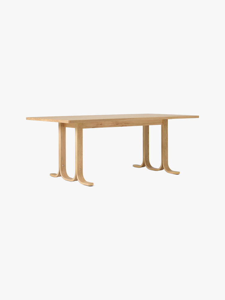 Rectangular white oak dining table with a bentwood base.