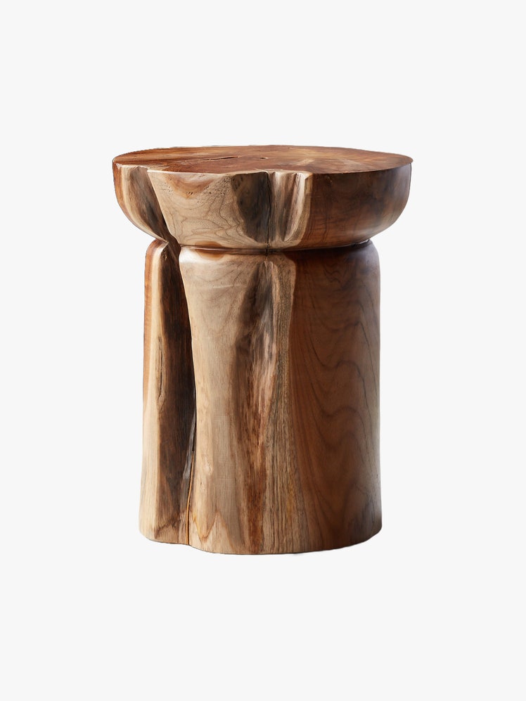 Teak wood stool with round organic shape.