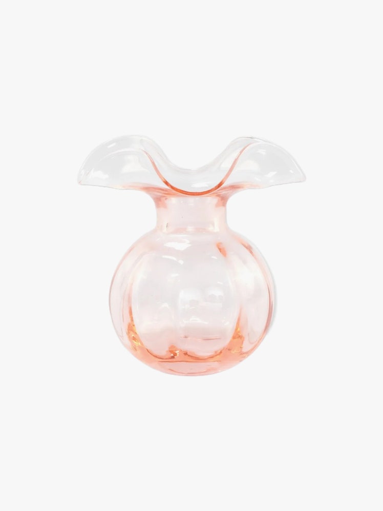 Pink glass bud vase with wavy lip.