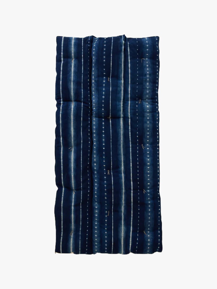 Rectangular mattress bedroll in navy with white stripes and polka dots.