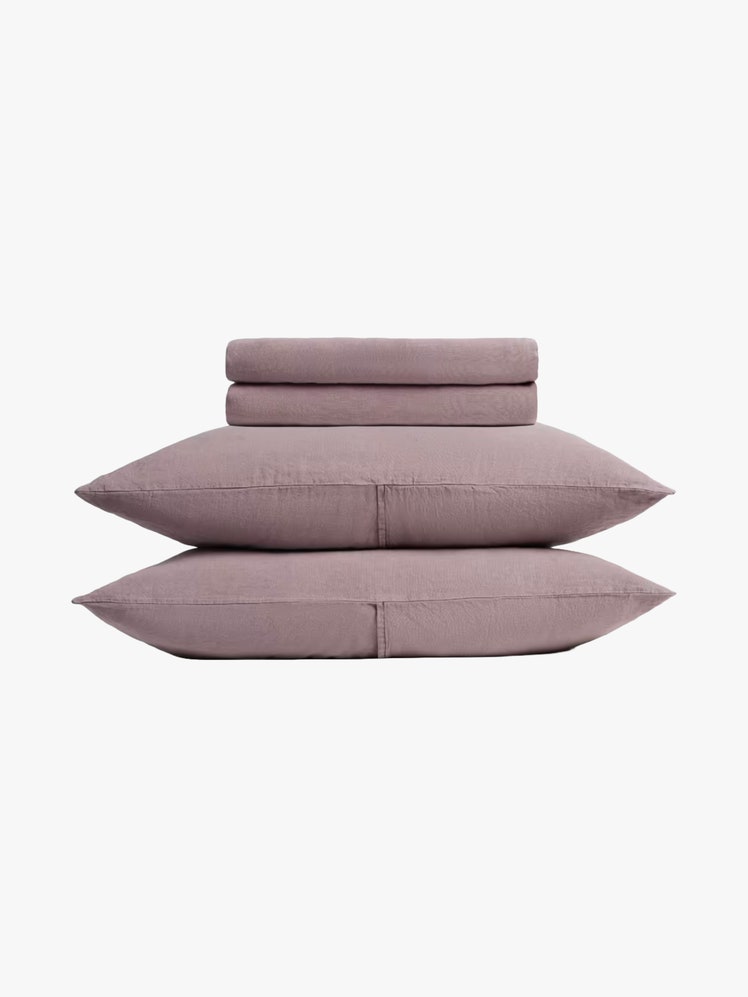 Two pillowcases and a set of folded sheets in purple.