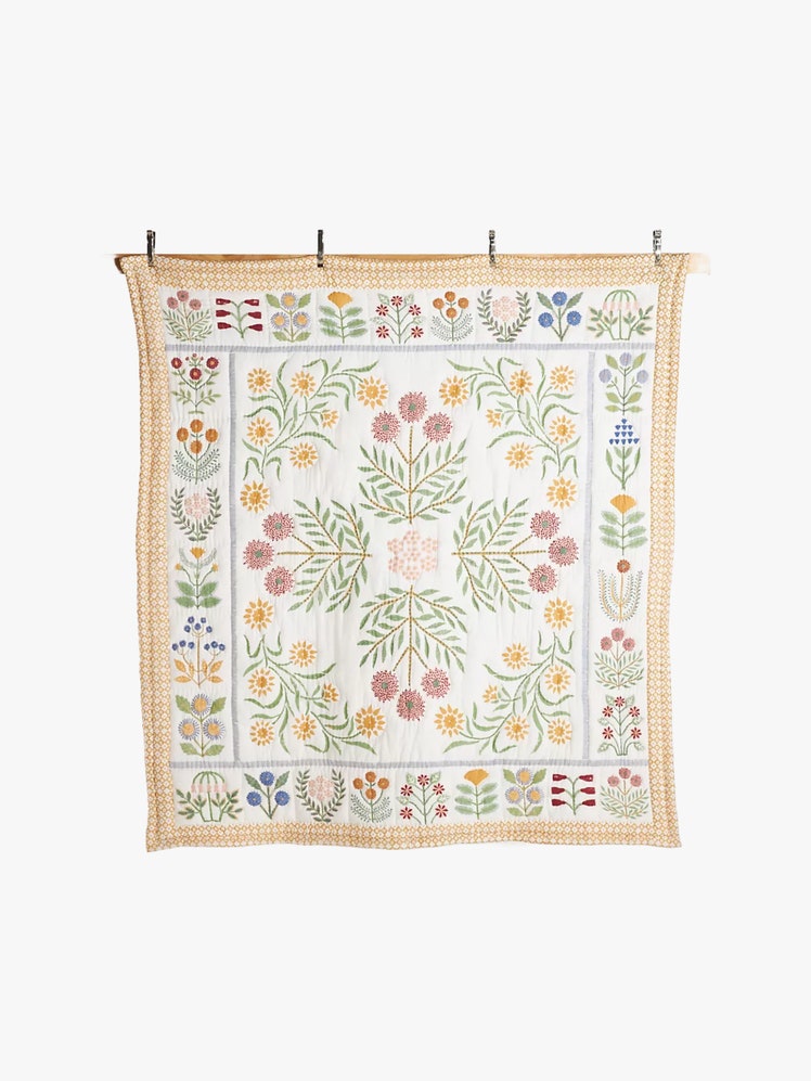 reversible quilt with floral motifs and diamond patterns.