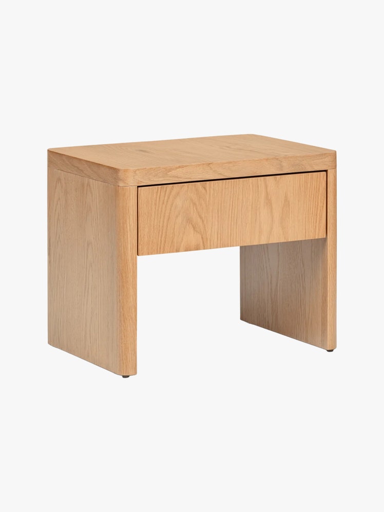 Pale wood nightstand with rounded edges and a single drawer.