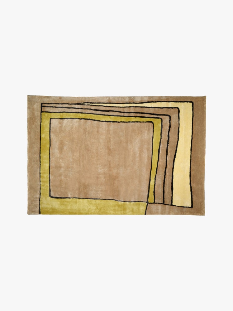 Rectangular rug with a biege background and a yellow abstract rectangular design on it.