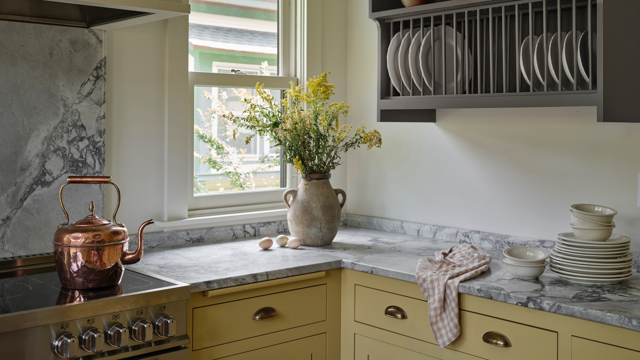 Image may contain Cooktop Indoors Kitchen Plate Rack and Interior Design