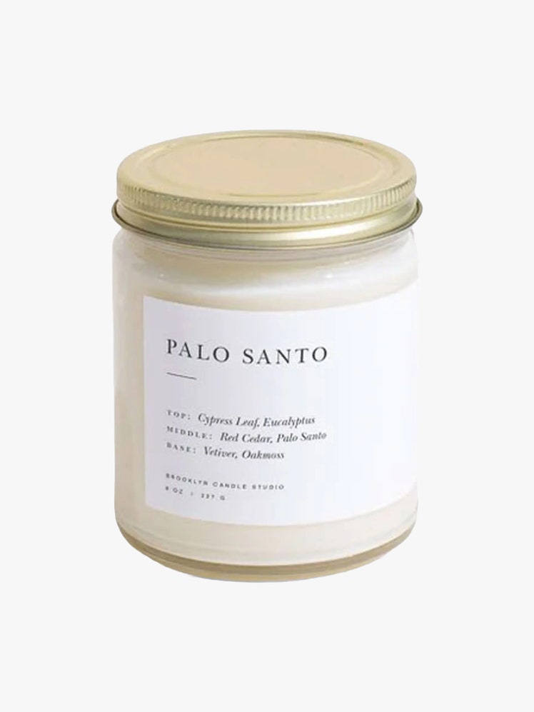 Brooklyn Candle Studio Palo Santo Candle in a clear jar with a gold metal lid.