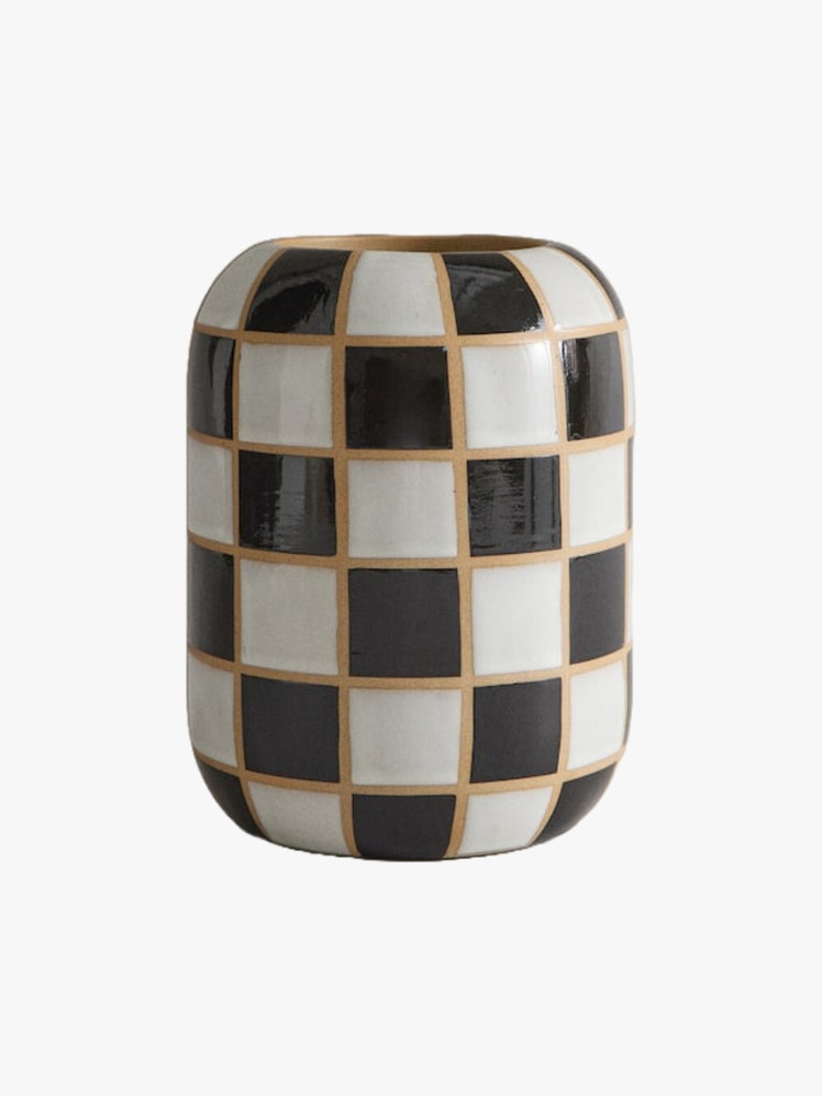 Cylindrical ceramic vase with a black and white chessboardstyle glaze.