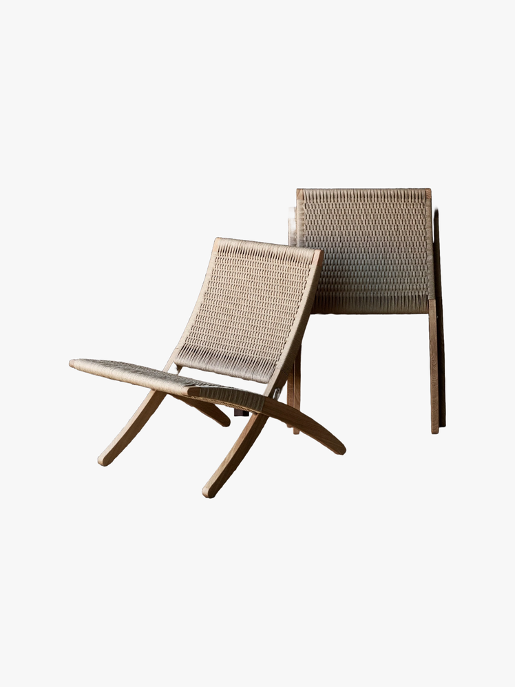 Handwoven folding chairs with wooden legs.