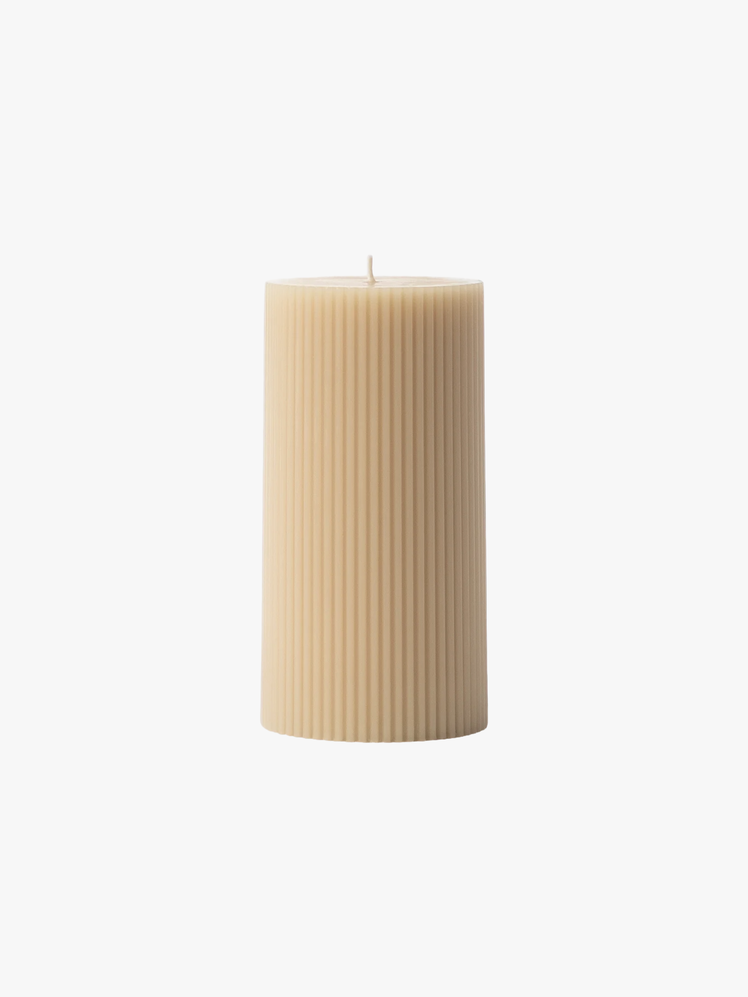 Ribbed Pillar Candle In a neutral hue.