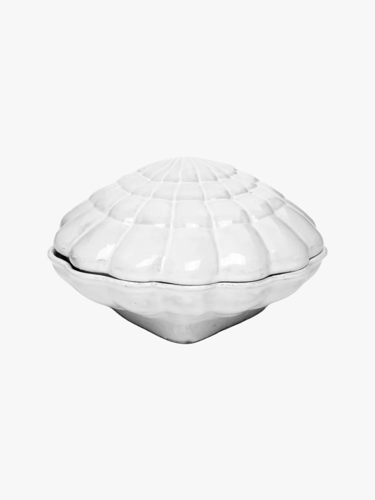 White ceramic box shaped like a shell with intricate etchings impressed into the glaze.