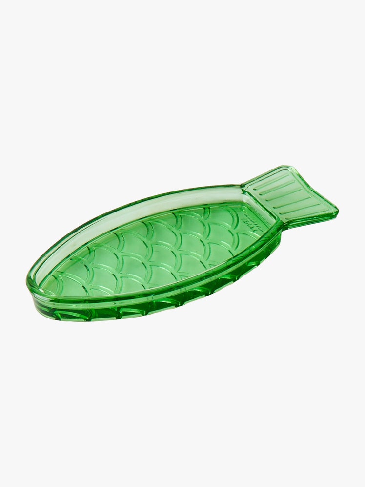 Green glass dish shaped like a fish.