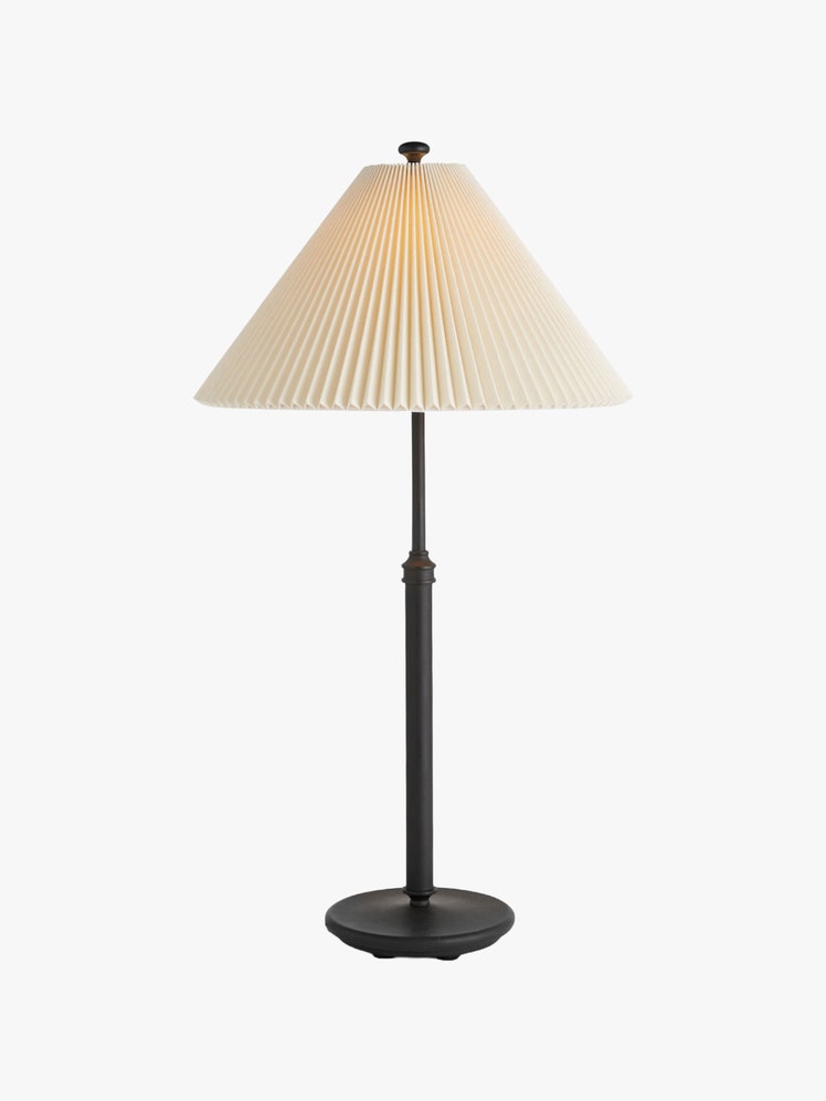 Table lamp with a black base and a pleated lampshade.