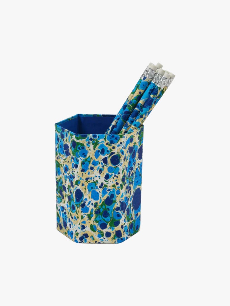 Hexagonal pencil cup and matching pencils all in a blue green and yellow marbled pattern.