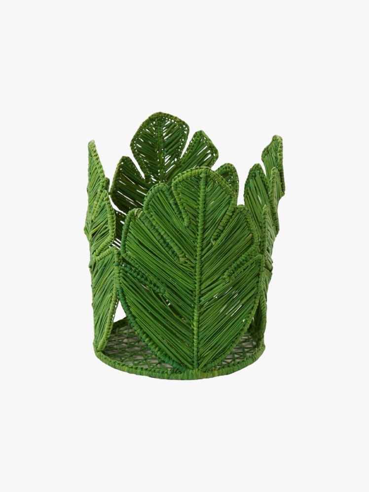 Circular candle holder made to look like leaves made out of green dyed woven natural fibers.