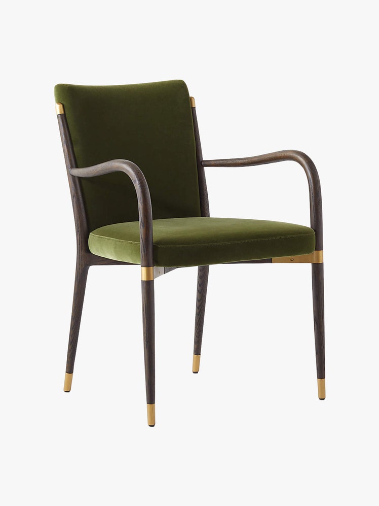 Armchair with a dark wood oak frame. curved arms brass accents and green velvet upholstery.