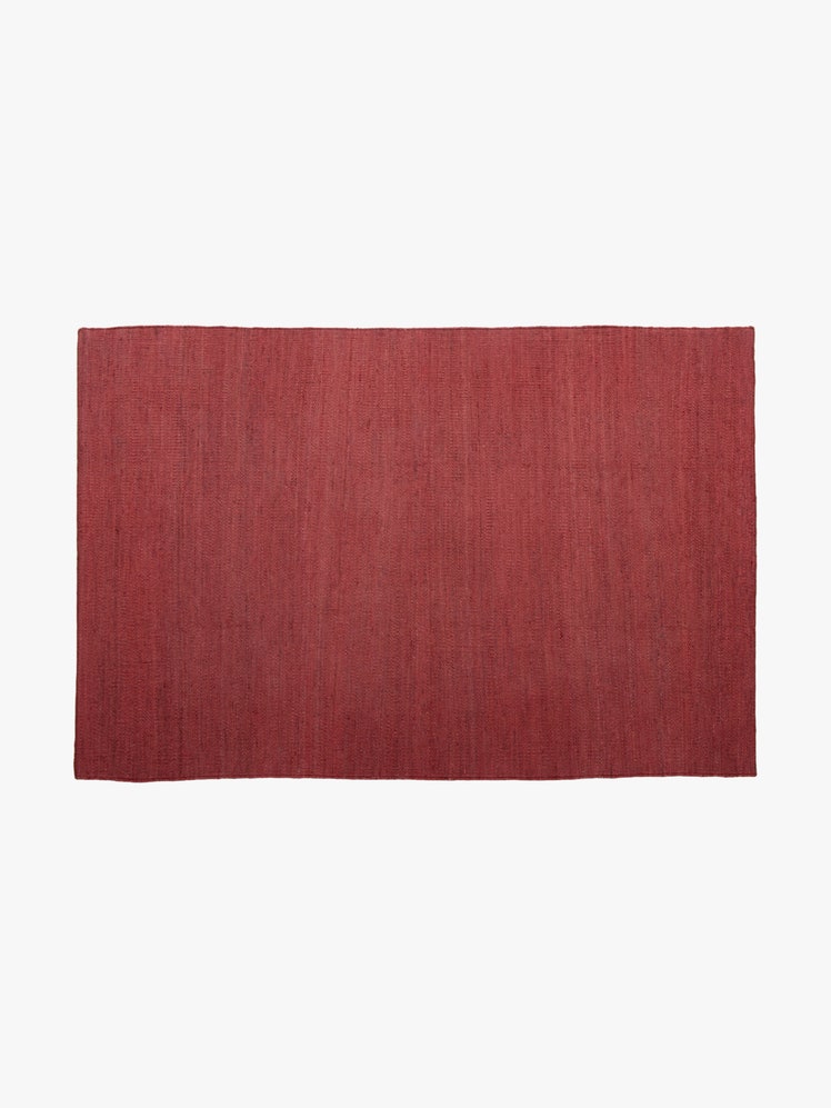 Rectangular crimson jute rug.