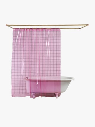 Pink translucent shower curtain hanging in front of a bathtub