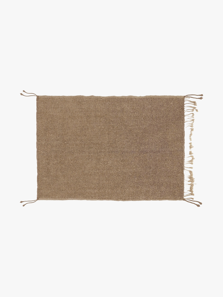 Tan area rug with fringe edges